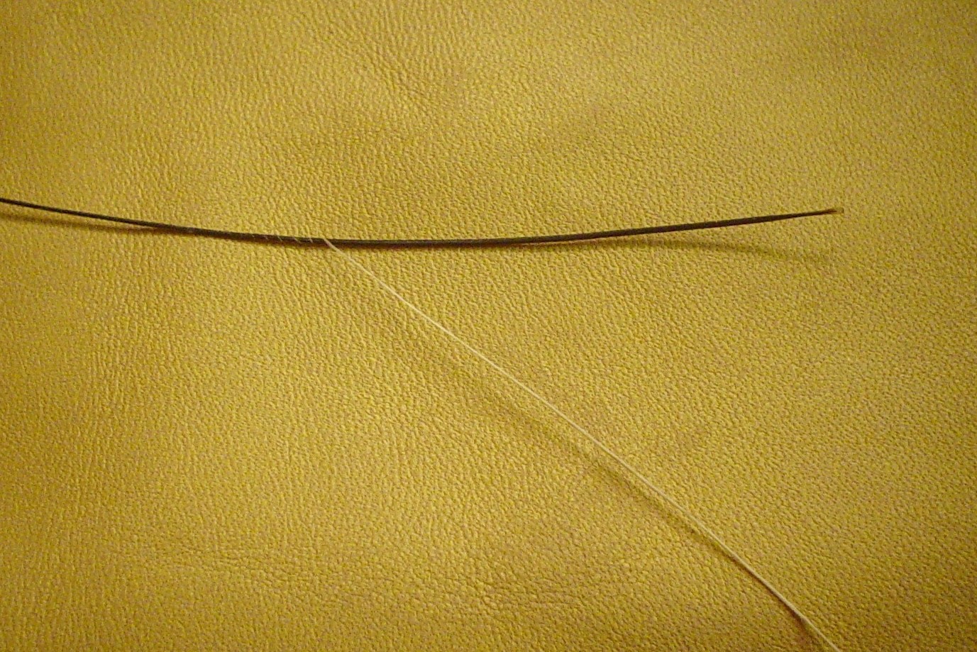 making a waxed end (winding linen around a boar bristle)